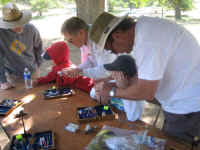 Club Members helping the kids tie flies at the JAKES event
